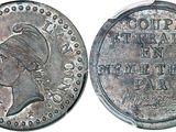 a close up of a coin with a woman ' s head on it