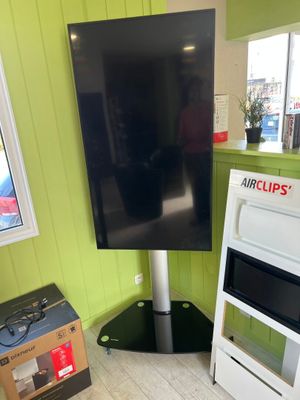 a television that is on a stand in a room