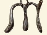 two spoons hanging from a chain on a white background