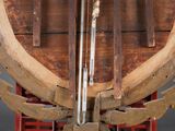 a large wooden object with a metal handle on a stand