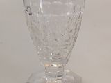 a clear glass cup sitting on top of a white table