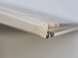 a pencil sticking out of a piece of paper on top of a shelf