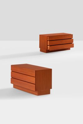 three pieces of wood are stacked on top of each other on a white surface