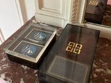 two books sitting on a marble table next to a mirror