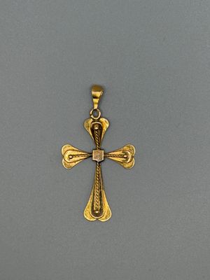 une image représentant une croix dorée sur fond gris