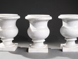 three white vases sitting on top of each other