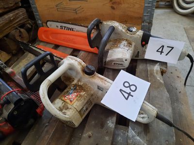 several chainsaws are sitting on a wooden table with a price tag