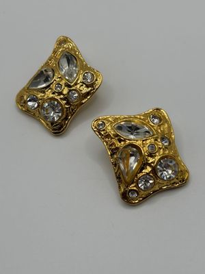 pair of gold tone earrings with clear stones