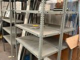 many shelves that are in a room with a lot of stuff
