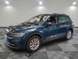 the blue volkswagen suv is parked on a checkered tile floor