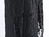 a woman wearing a black lace dress with long sleeves