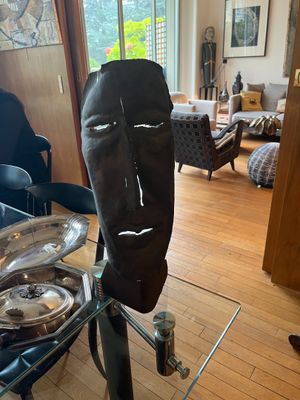 a sculpture of a face on a glass table in a living room
