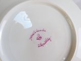a white plate with a pink design on it