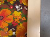 a chair that has a flower print seat cover on it