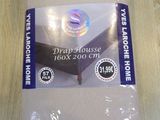 a package of bed sheets sitting on a wooden table