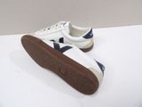 white and blue sneakers with brown soles on a white surface
