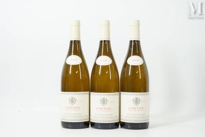 three bottles of wine sitting on top of a table next to each other