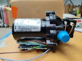a close up of a water pump on a table with wires