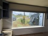 a window with a view of a field outside of it