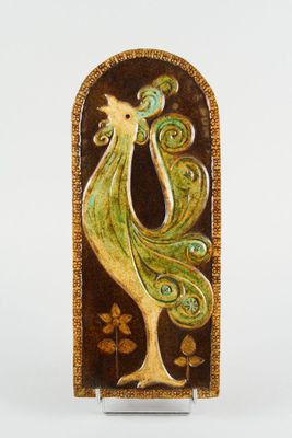 a ceramic sculpture of a bird on a stand