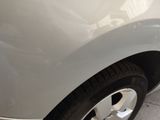 a close up of a car ' s tire on the side of the road