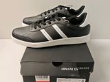 black and white adidas sneakers with white stripes on top of a box
