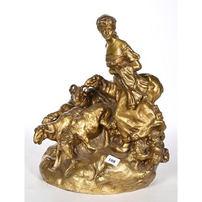statue en bronze représentant une femme assise sur un rocher, entourée de chiens et de moutons
