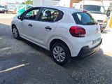 a small white car parked in a parking lot