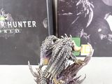 a silver statue of a bird sitting on top of a box