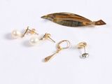 three pairs of pearl and gold earrings on a white surface