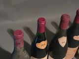 several bottles of wine are lined up on a table
