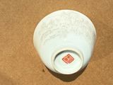 a white bowl sitting on a brown surface
