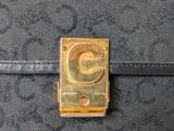 a close up of a black purse with a gold letter g on it
