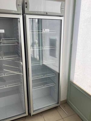 two refrigerators that are open in a kitchen