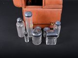 a brown purse with four salt and pepper shakers in it