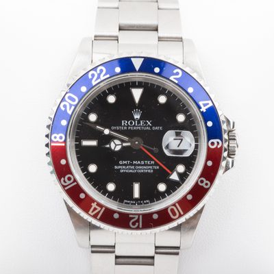 an image of a rolex watch with a red, white and blue bezel