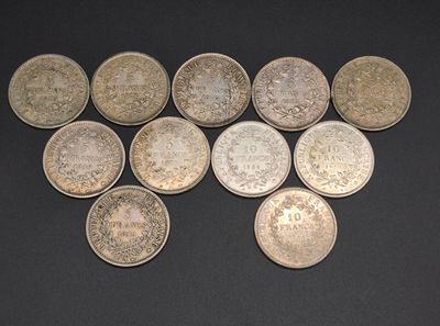several different types of coins are arranged on a black surface