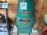 a green machine that is sitting next to another machine