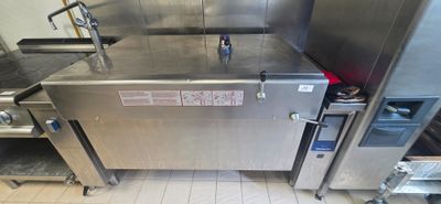 a large stainless steel oven sitting in the middle of a kitchen