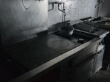 a kitchen with a stove, sink, and oven in it
