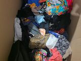 a cardboard box filled with clothes and other items