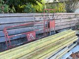 a pile of old wood and a metal bed in the yard