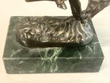 a bronze statue of a man holding a fish on a marble base