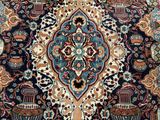an antique persian rug with a floral design on a blue ground