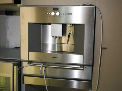 a stainless steel oven with a built in coffee maker
