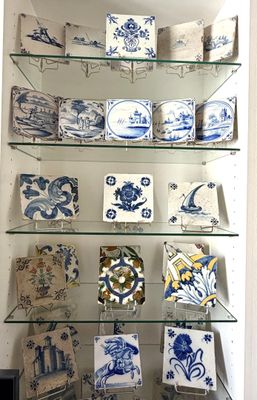 a glass shelf with blue and white plates on it