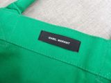 a close up of a green bag with a label on it