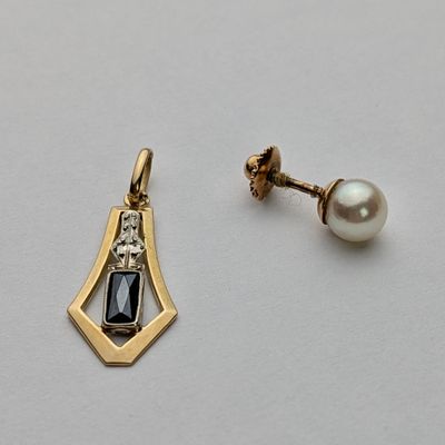 pair of earrings with black and white stones on a white surface