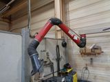 a red robot that is standing in a garage