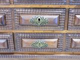 a wooden dresser with many drawers and knobs on it